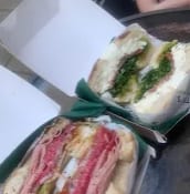 Two loaded bagels in takeaway boxes from Shan's visit
